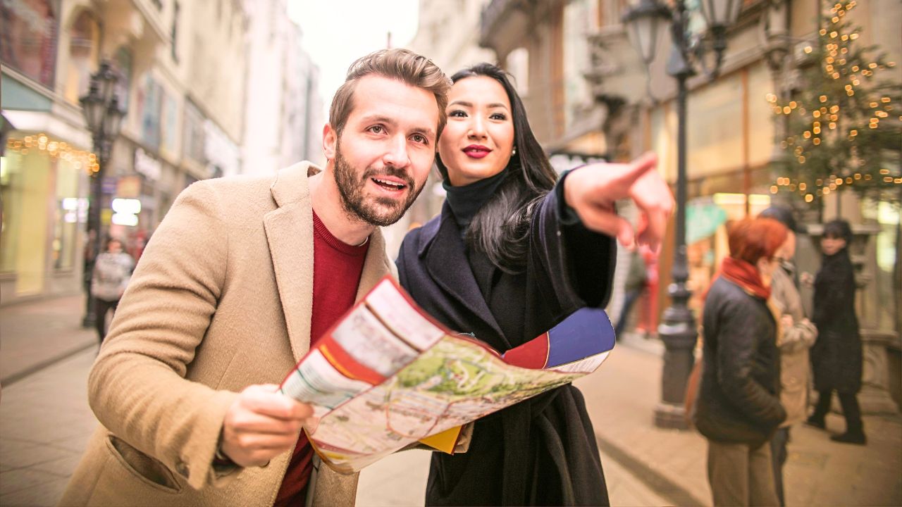 A couple overlooking a European cityscape at sunset, representing diverse travel styles and destinations across Europe.