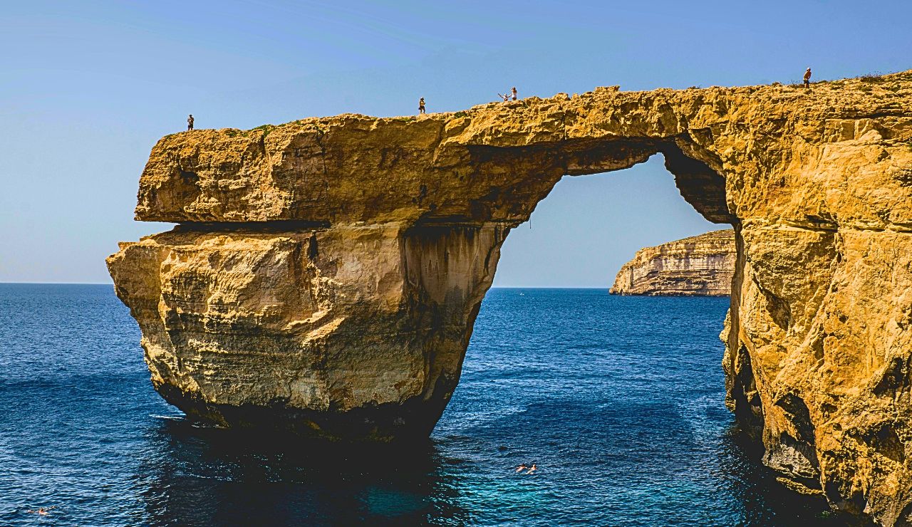 Limestone cliffs surround the clear Inland Sea on Gozo Island, Malta.