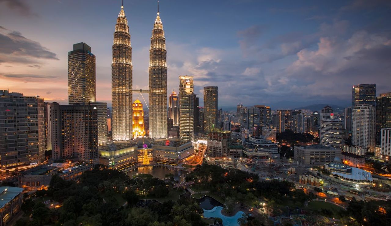 Petronas Twin Towers illuminated at dusk in Kuala Lumpur, Malaysia.