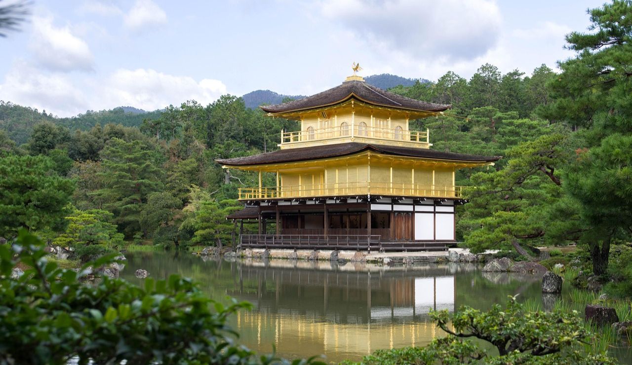 Golden Pavilion (Kinkaku-ji) reflecting on a tranquil pond in Kyoto, Japan.