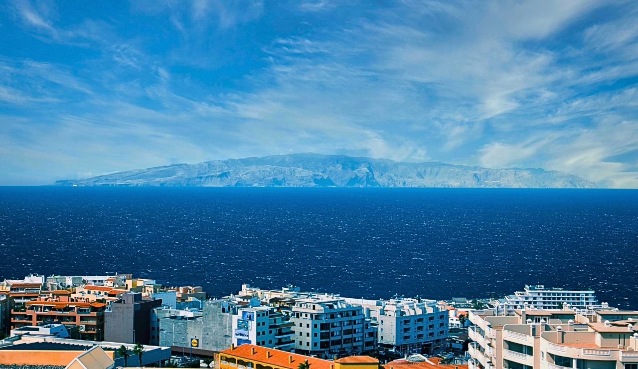 Palm-lined valley and volcanic cliffs on La Gomera, Canary Islands.