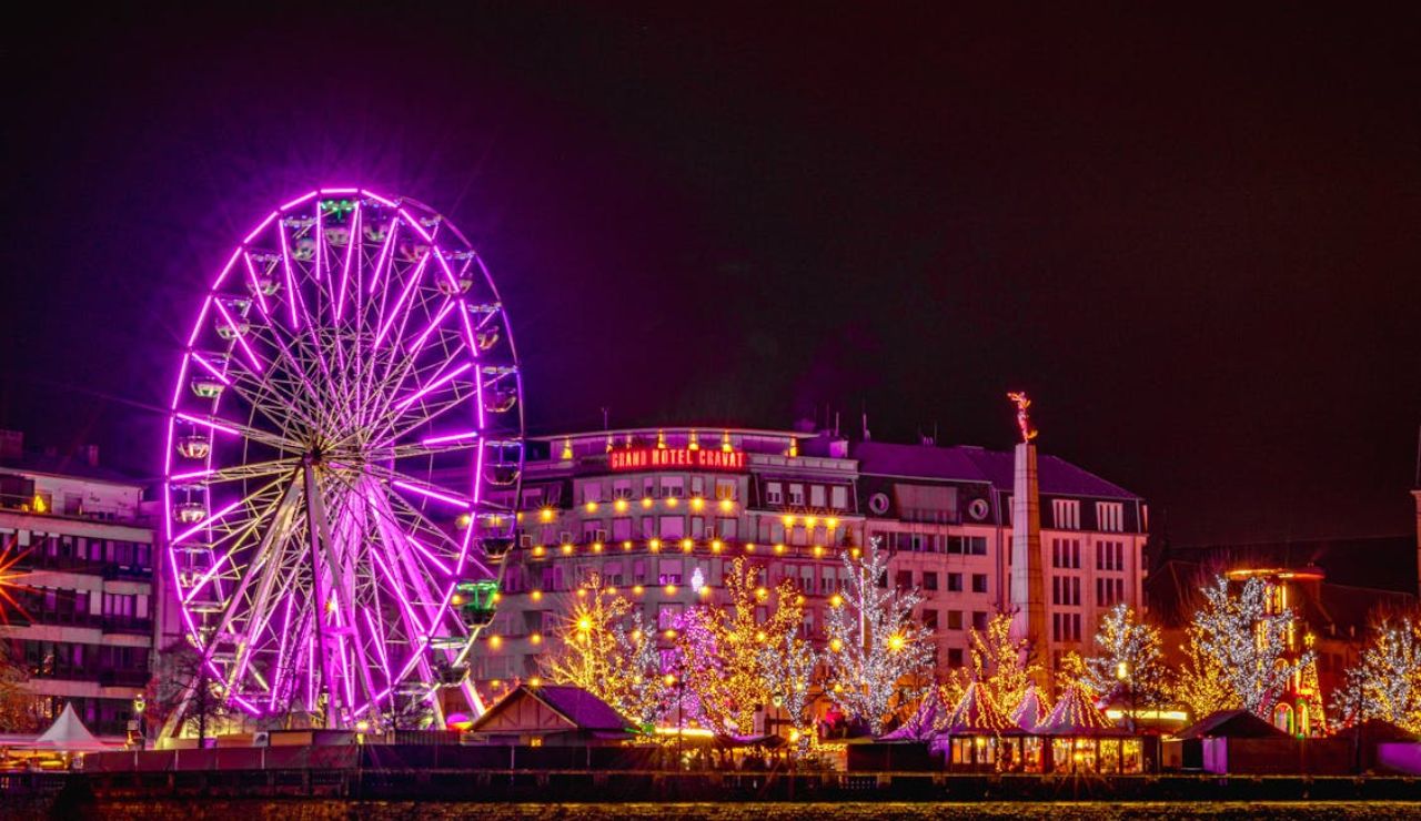 Night view of Ferris wheel and festive lights near Grand Hôtel Cravat, Luxembourg City.