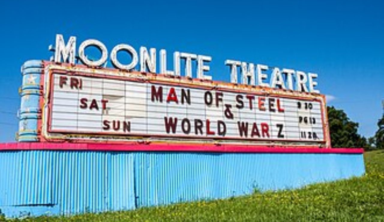 Colorful retro sign for Moonlite Theatre displaying Man of Steel and World War Z.