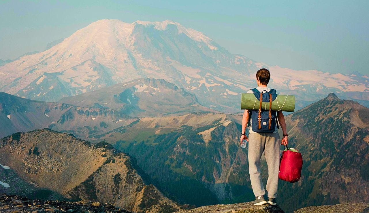 View of Mount Rainier with alpine meadow and hiking trail in foreground