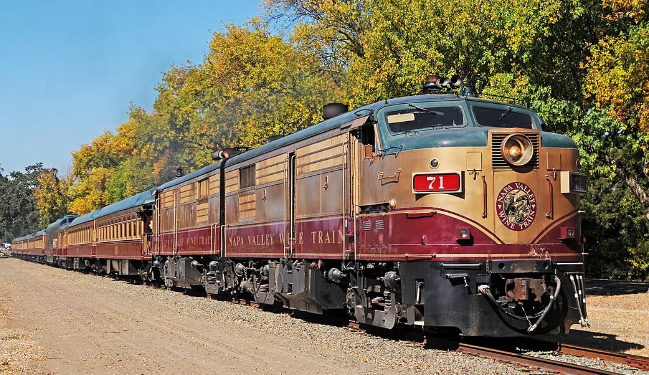 Vintage Napa Valley Wine Train passing through vineyards in Napa Valley, California.