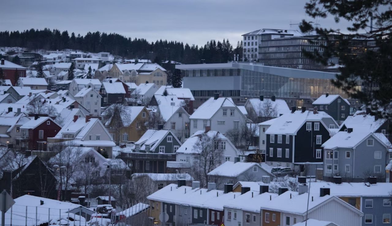 Snow-covered houses and modern buildings in the winter cityscape of Narvik, Norway.