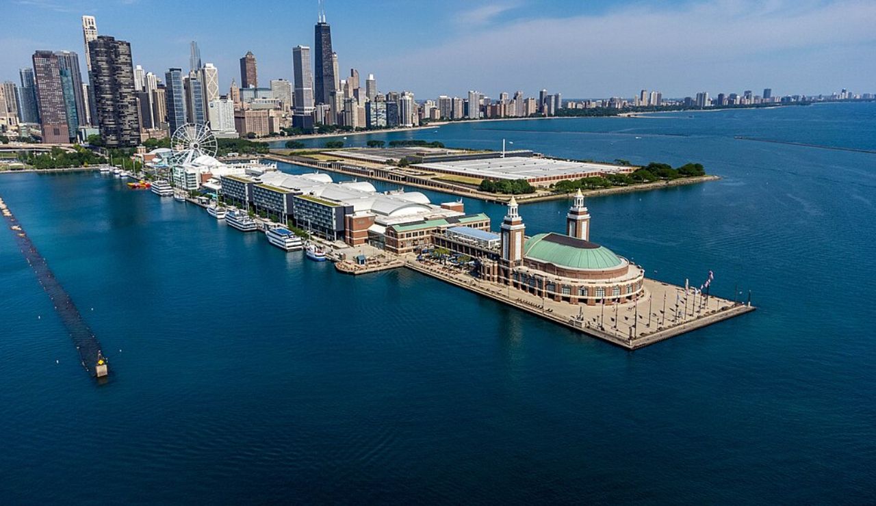 Aerial view of Navy Pier extending into Lake Michigan with the Chicago skyline in the background on a clear day