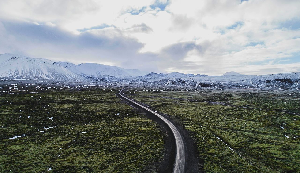 Mountain road with dramatic peaks and evergreen forests