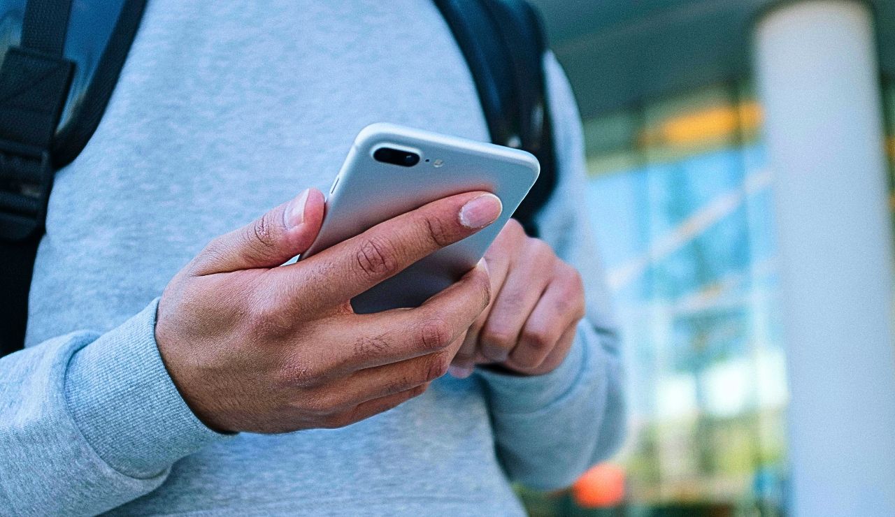 A close-up of a hand holding a phone.