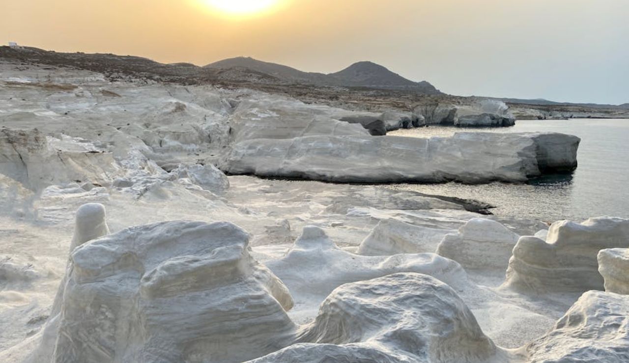 Sunset over the white volcanic rock formations of Sarakiniko Beach, Milos.