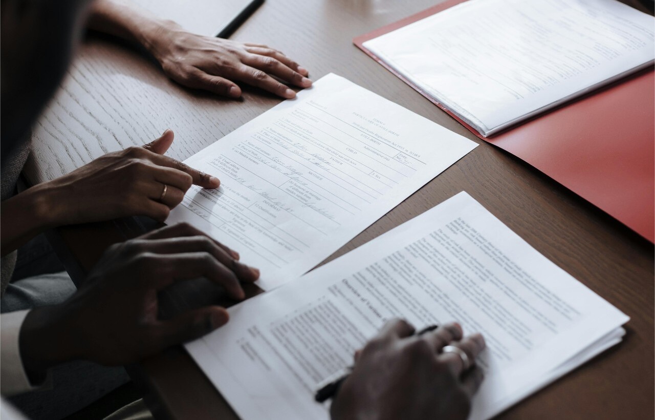 Signing official documents at a desk.