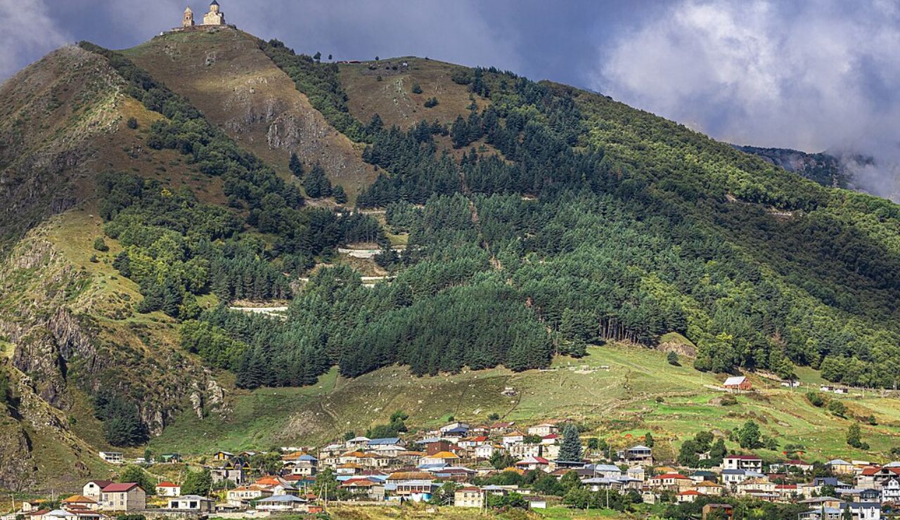 Picturesque view of Stepantsminda, Georgia, with the Gergeti Trinity Church perched above.