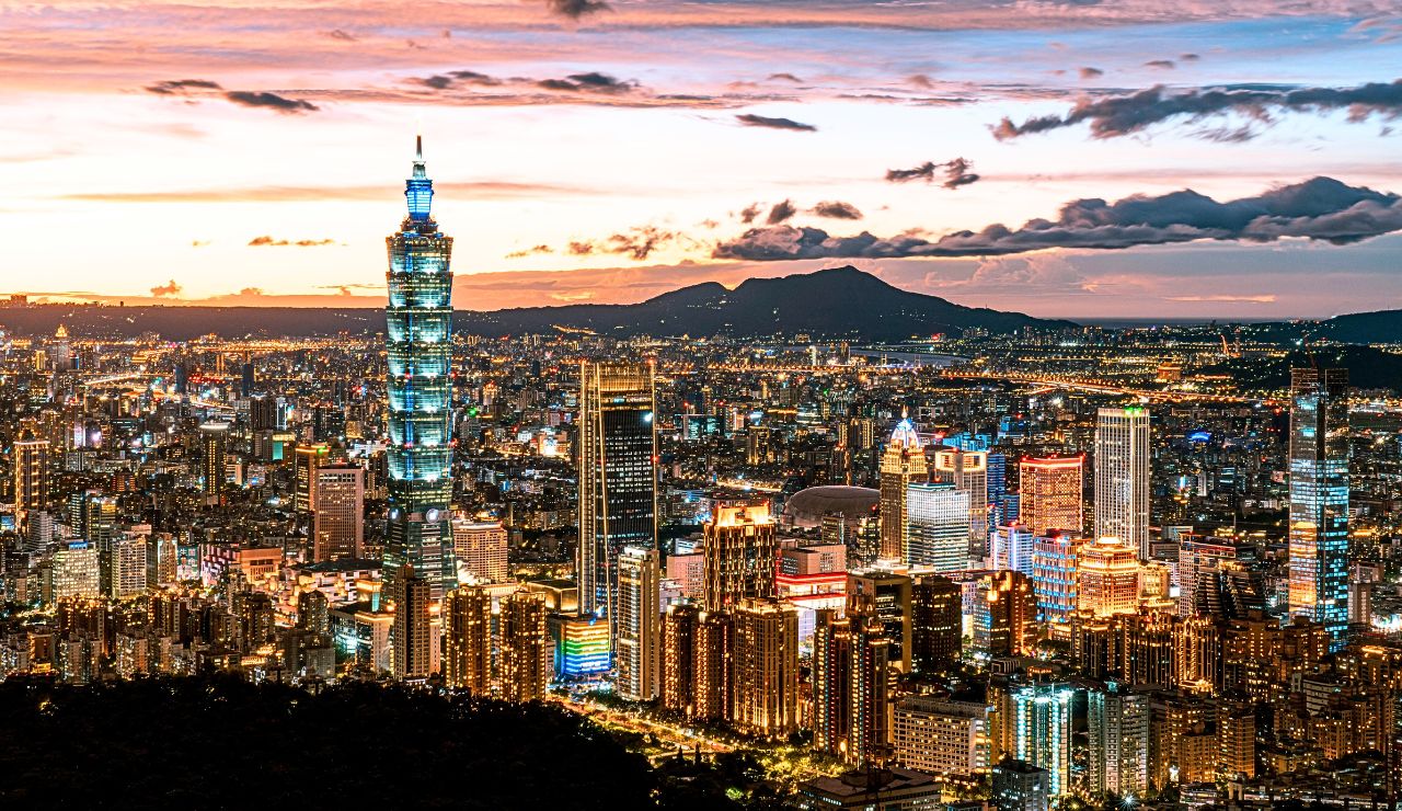 Taipei 101 rising above the city at golden hour.