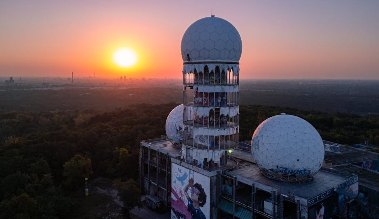 Abandoned Teufelsberg spy station in Berlin with radar domes at sunset.