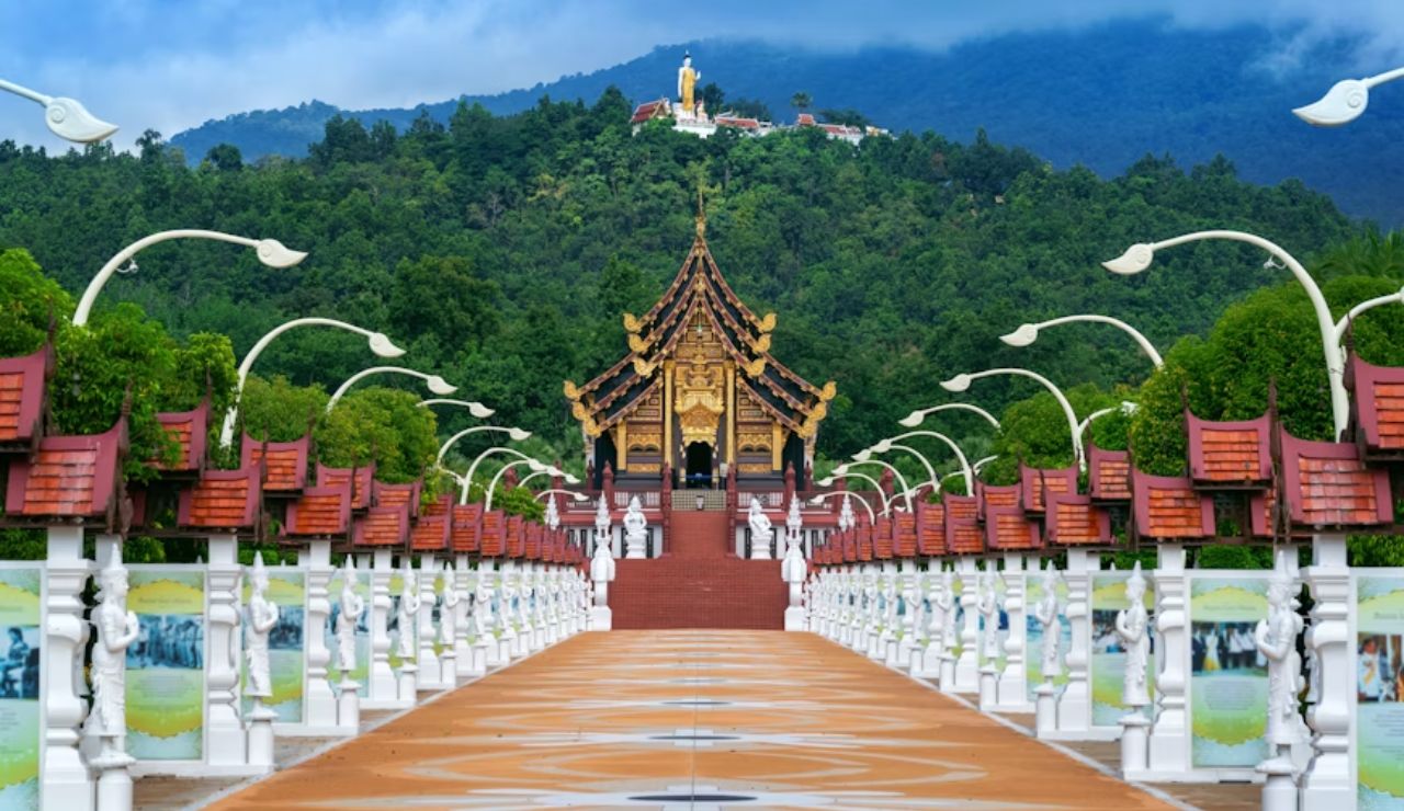 Ornate Thai pavilion with mountainous backdrop at Royal Park Rajapruek in Chiang Mai.