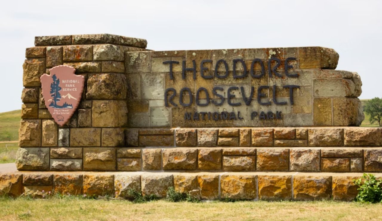 Stone entrance sign for Theodore Roosevelt National Park in North Dakota.