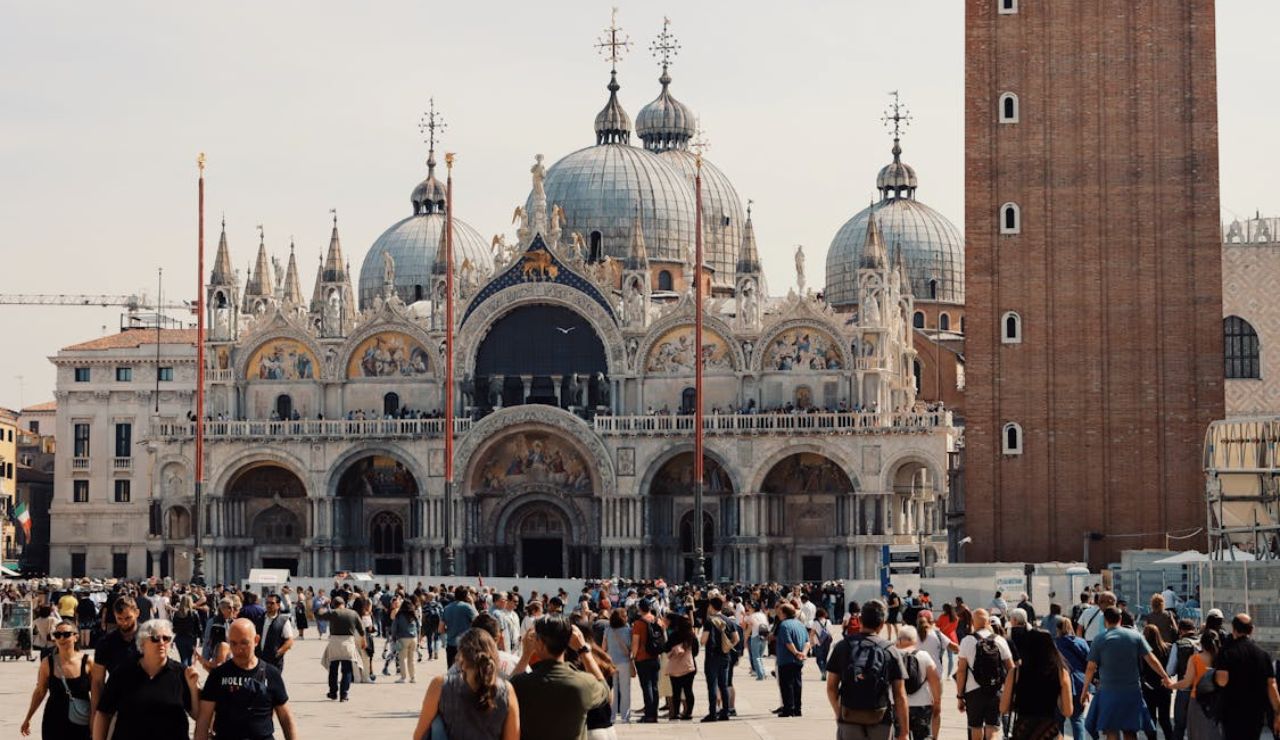 Crowds in front of the ornate St. Mark's Basilica in Venice, Italy.