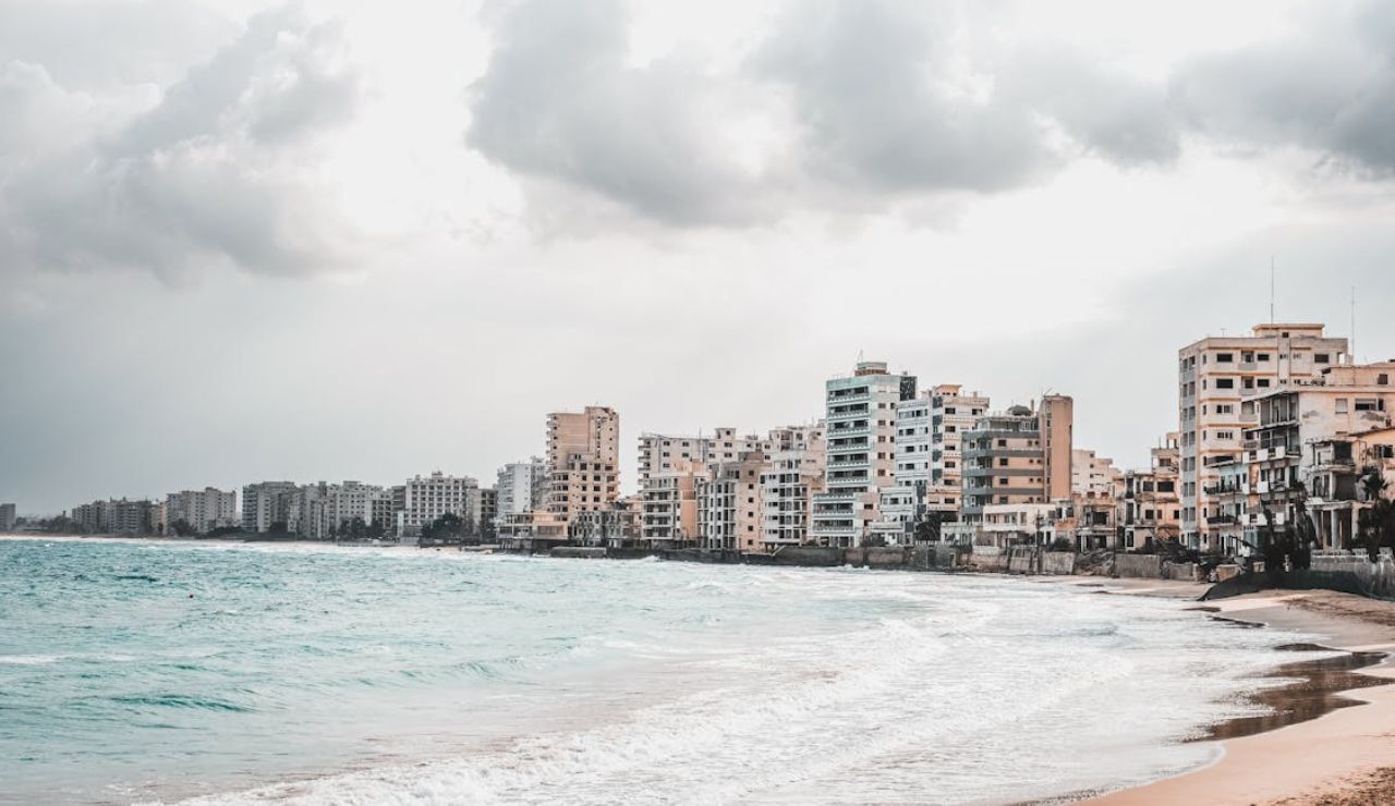 Abandoned beachfront buildings in Varosha, Cyprus under cloudy skies.
