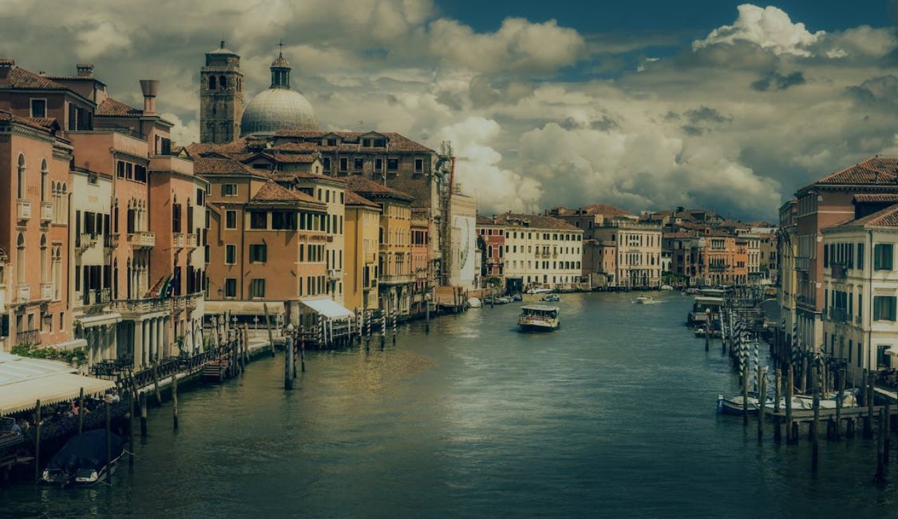 Scenic view of Venice Grand Canal with colorful buildings and boats.