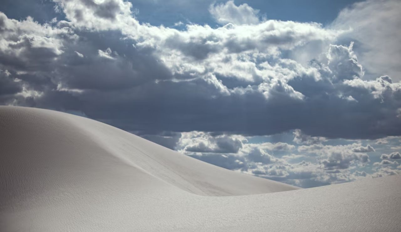 White sand dunes under dramatic clouds at White Sands National Park, New Mexico.