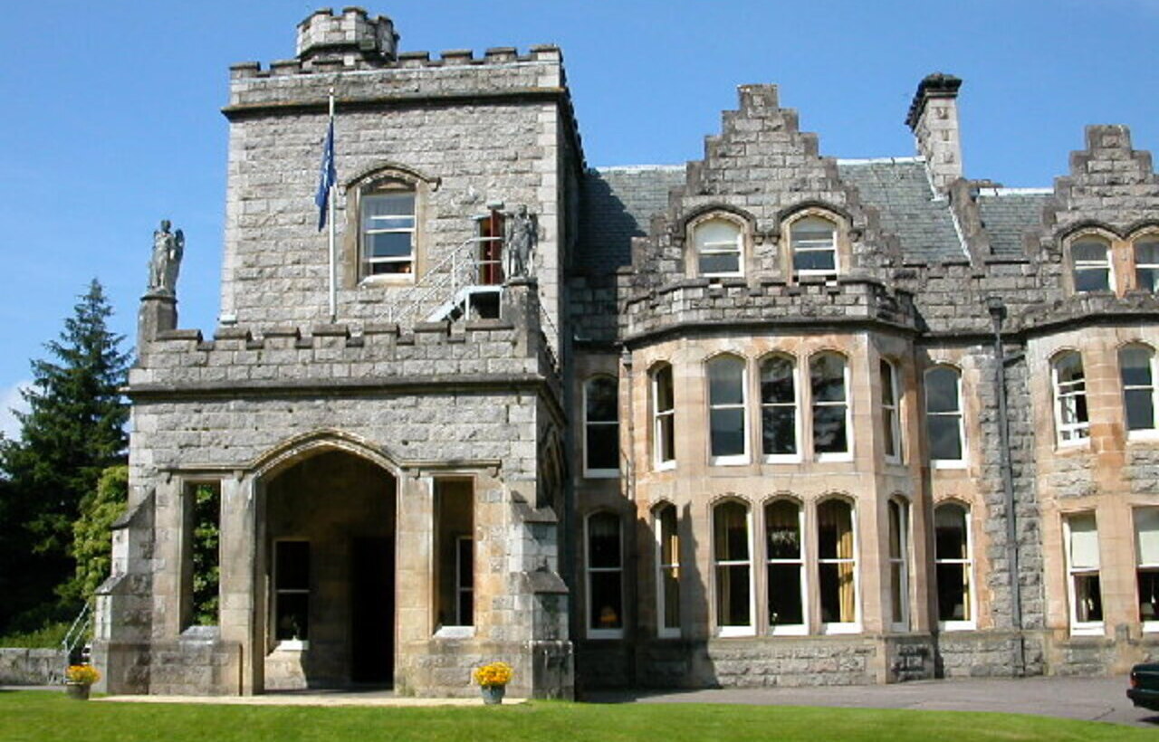 Inverlochy Castle’s stone facade with arched entrance in Fort William, Scotland.