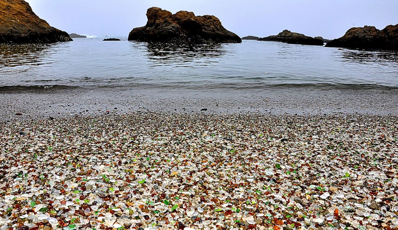 Multicolored sea glass glistening under sunlight on the shoreline of Glass Beach.