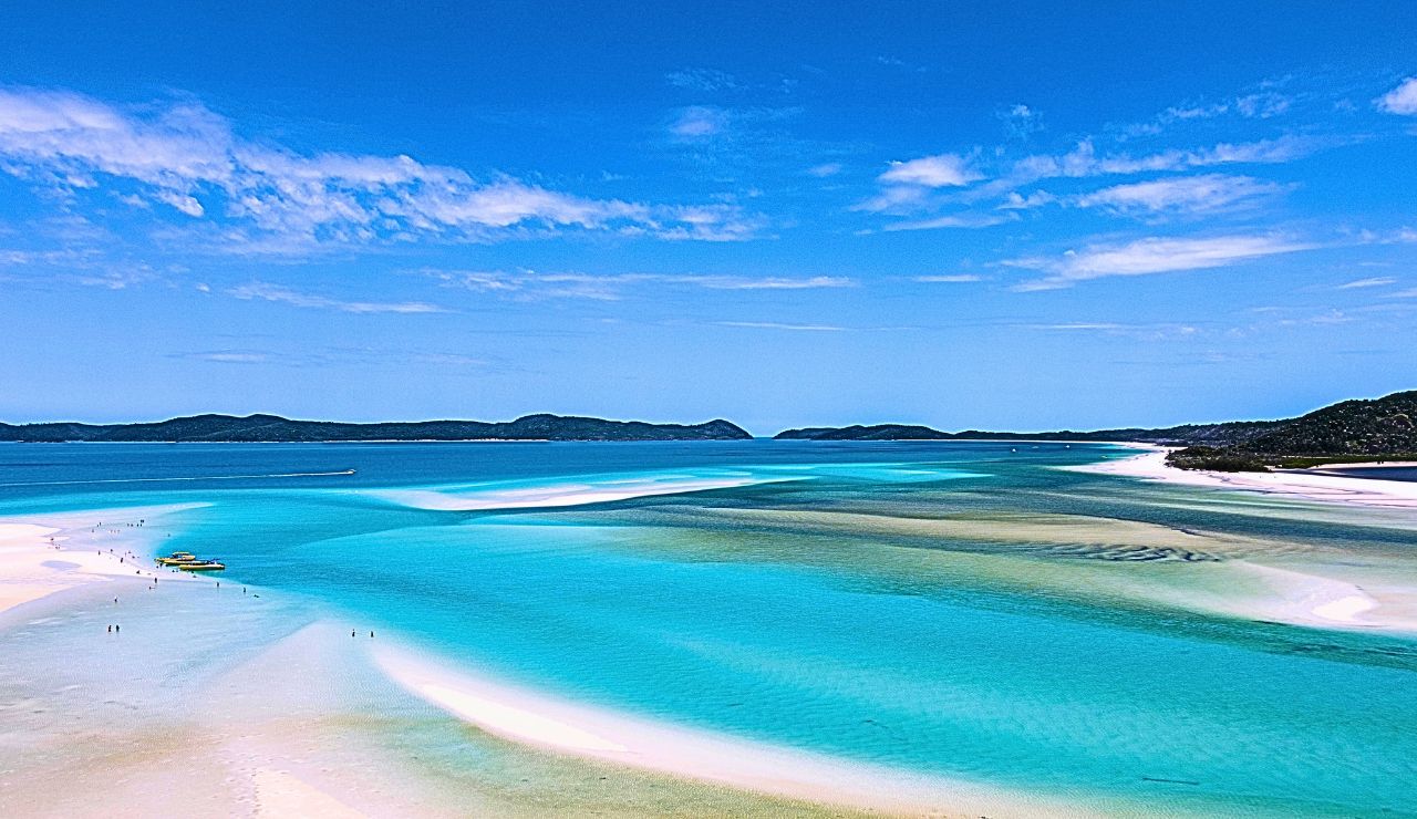 Aerial view of swirling silica sand bars and turquoise waters at Whitehaven Beach.