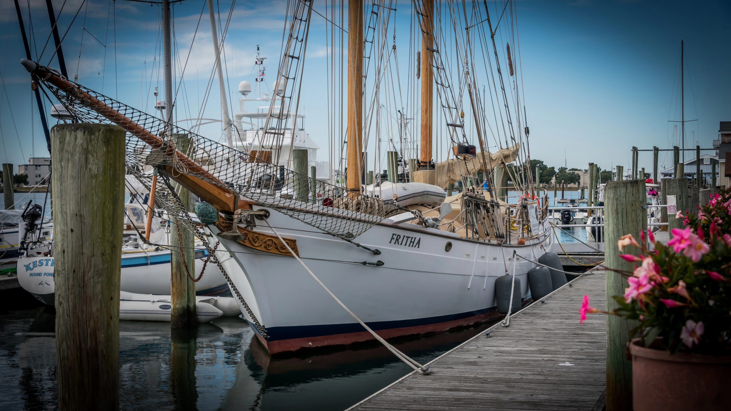 A dock leading to a traditional Switzerland sail boat in Beaufort, North Carolina.