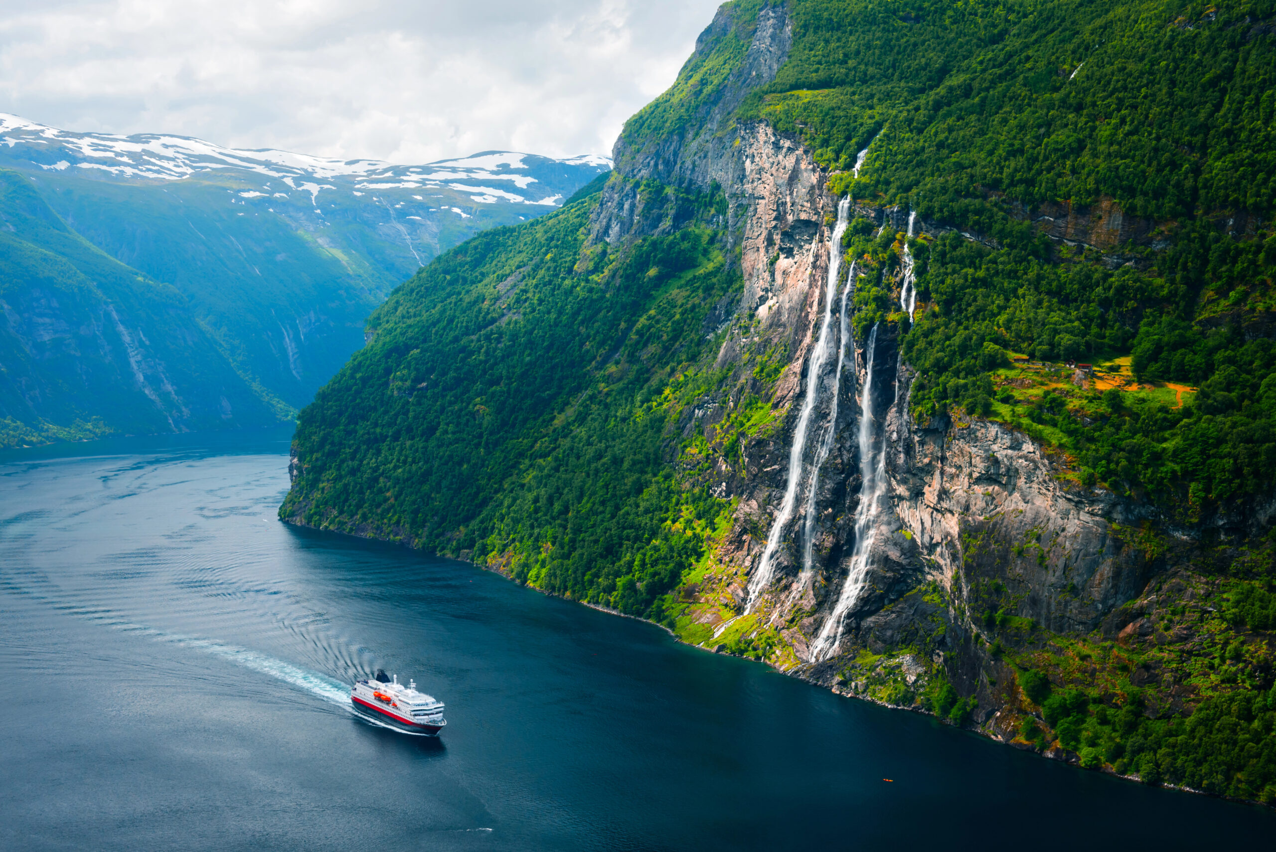 Giant Norway fjords with a cruise ship floating by.