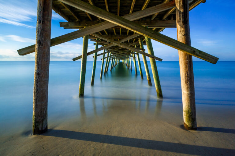 View from under a dock in Emerald Isle, leading to the ocean.