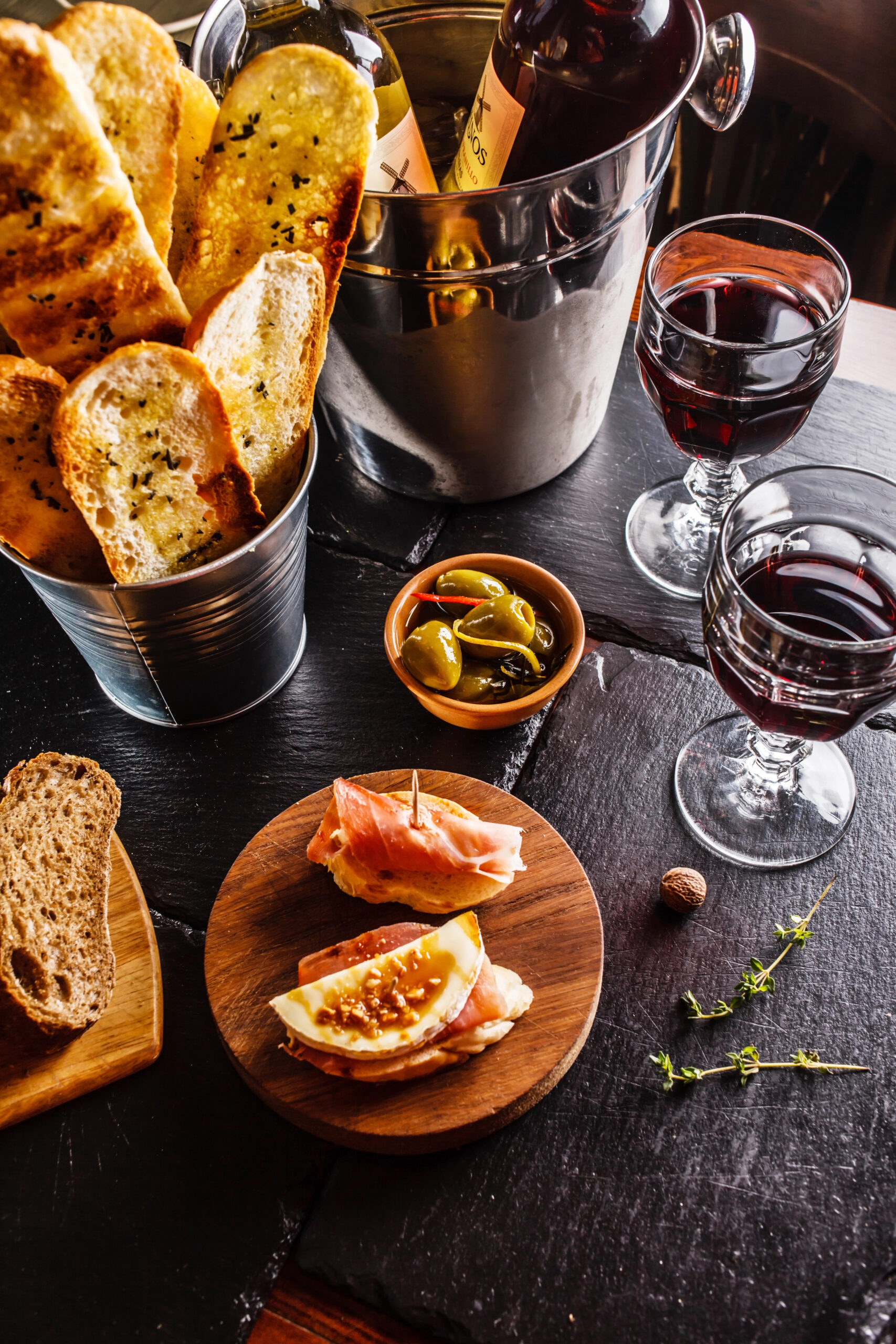 Spanish tapas on a black table.