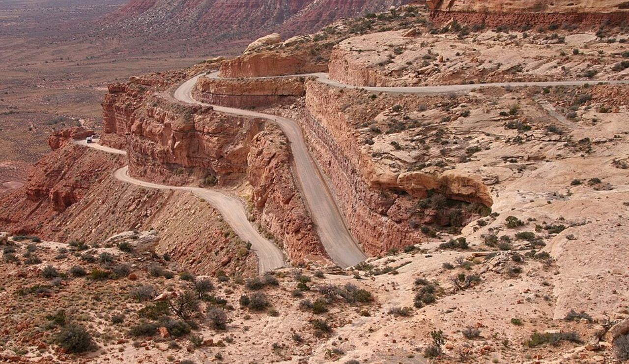 Winding Moki Dugway road carved into steep Utah desert cliffs.
