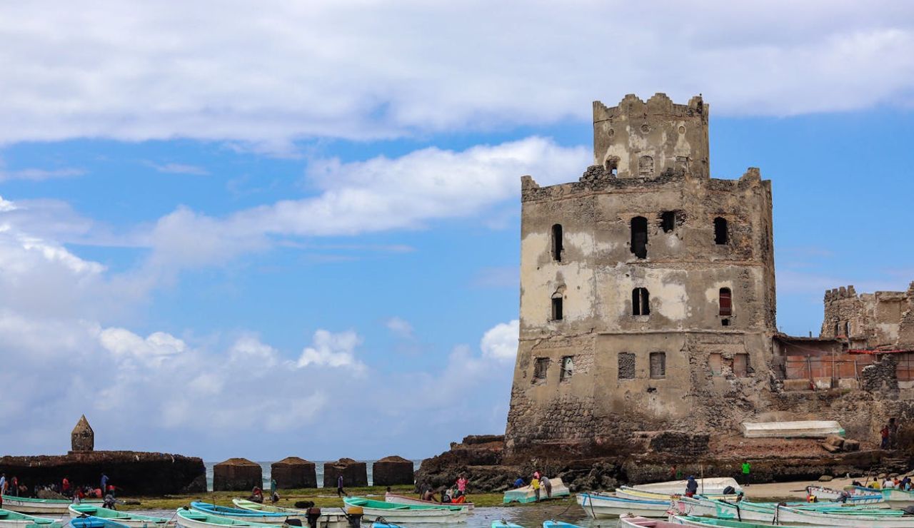 Mogadishu, Somalia – Historic coastal fort alongside colorful fishing boats.
