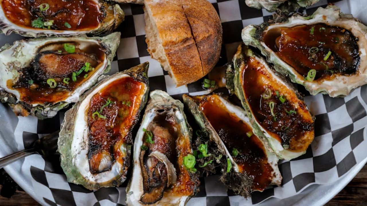 Grilled oysters are a Seattle staple, often served smoky, saucy, and topped with scallions. A must-try for seafood lovers.