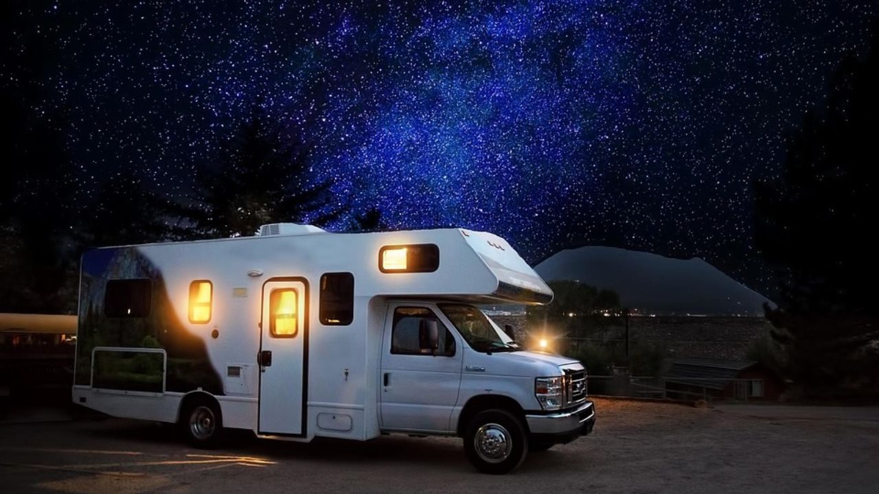 RV parked under a star-filled sky, highlighting the peaceful beauty of nighttime road life.