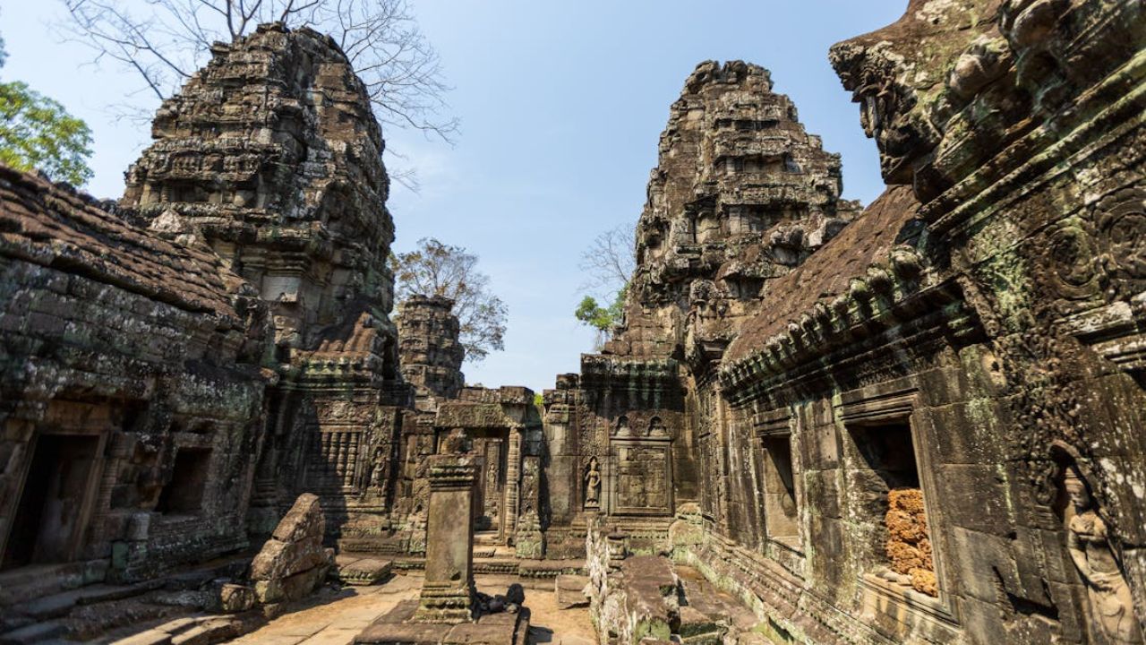 Ancient stone temple ruins in Cambodia under a clear blue sky