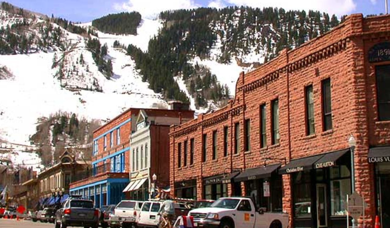 Downtown Aspen, Colorado with historic buildings and snowy mountain slopes in the background