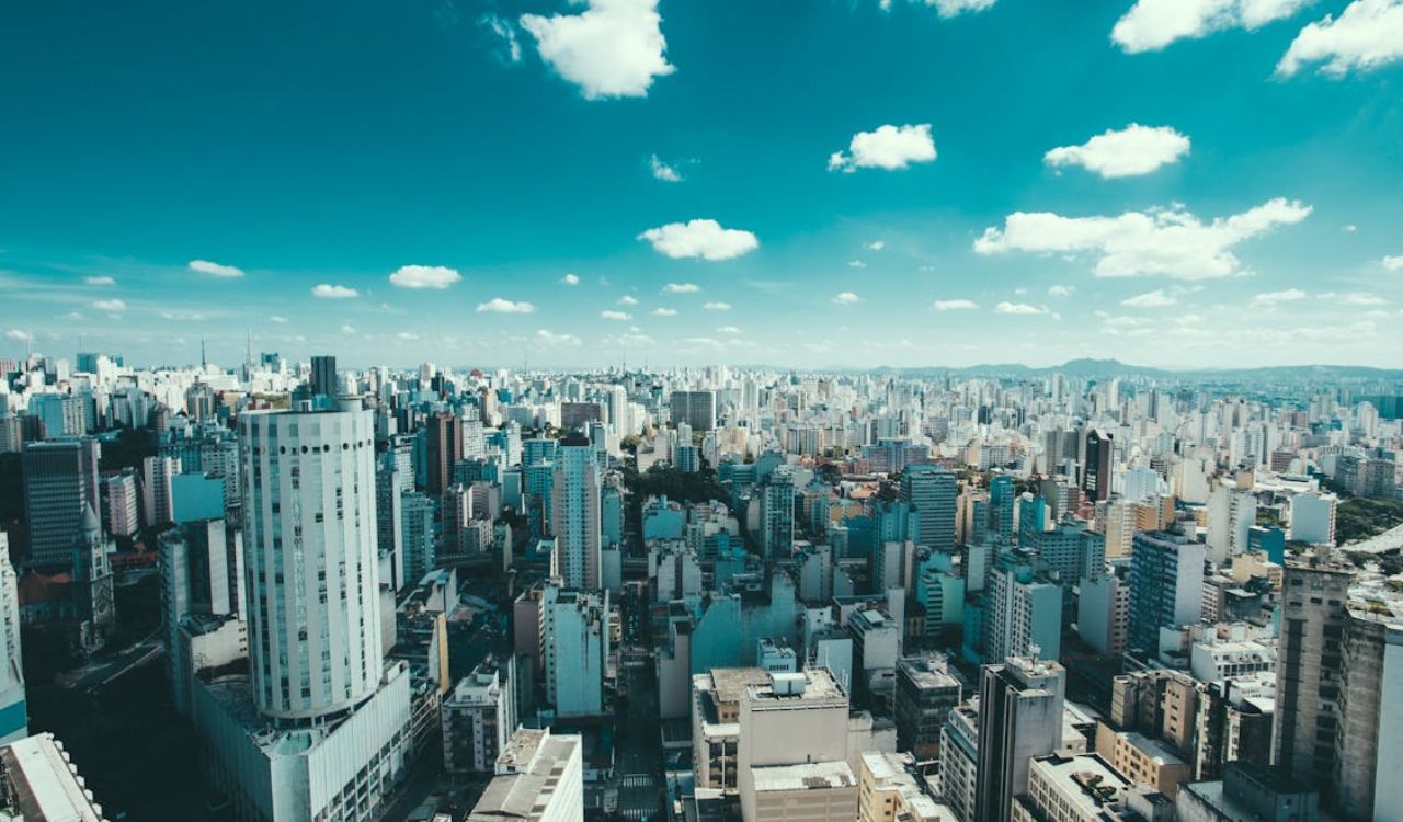 Expansive skyline of São Paulo, Brazil, filled with high-rise buildings under a blue sky