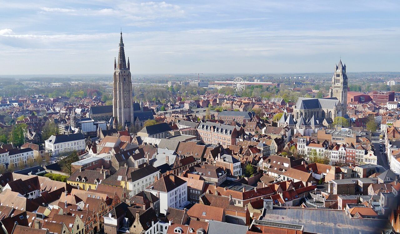 Aerial view of Bruges, Belgium with historic churches and red rooftops
