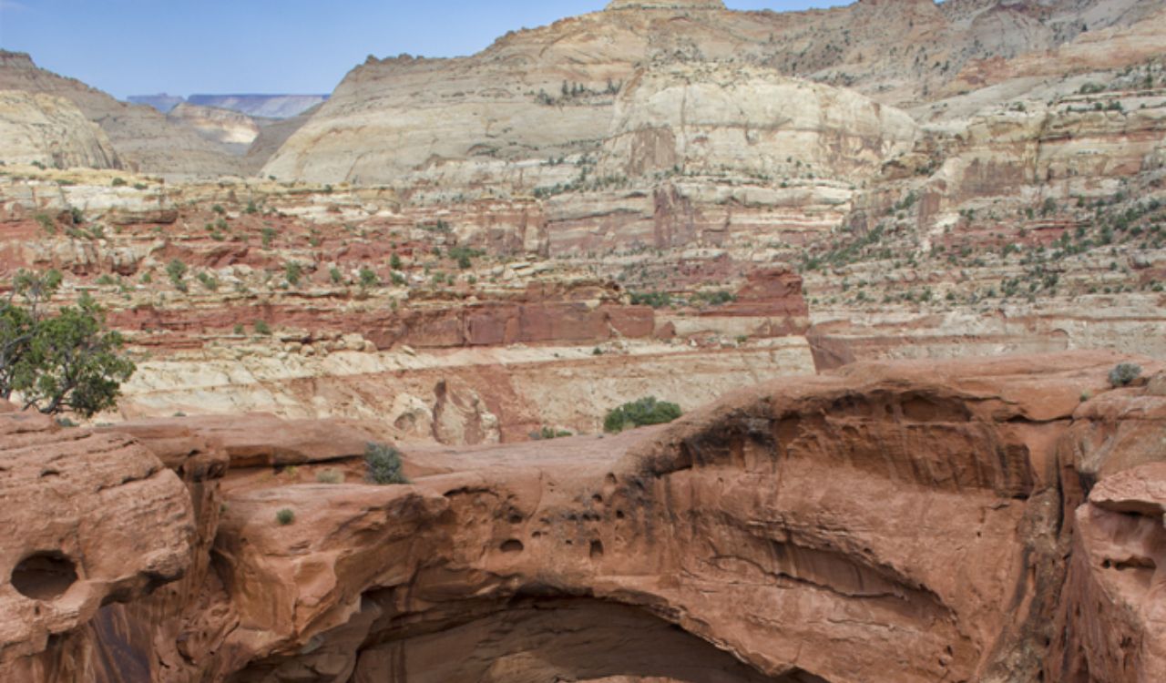 Natural red rock arch in a rugged desert canyon at Capitol Reef National Park, Utah