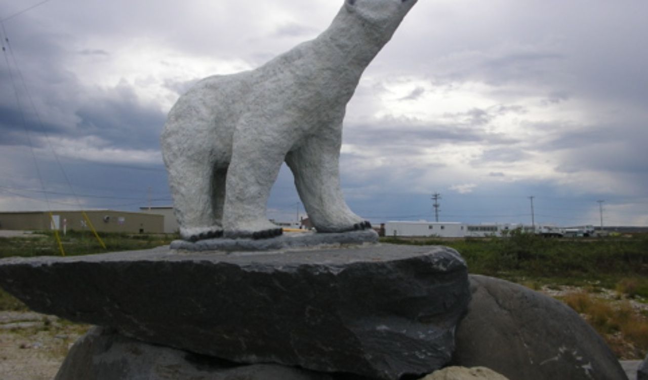 Polar bear statue on a rock pedestal in Churchill, Manitoba.