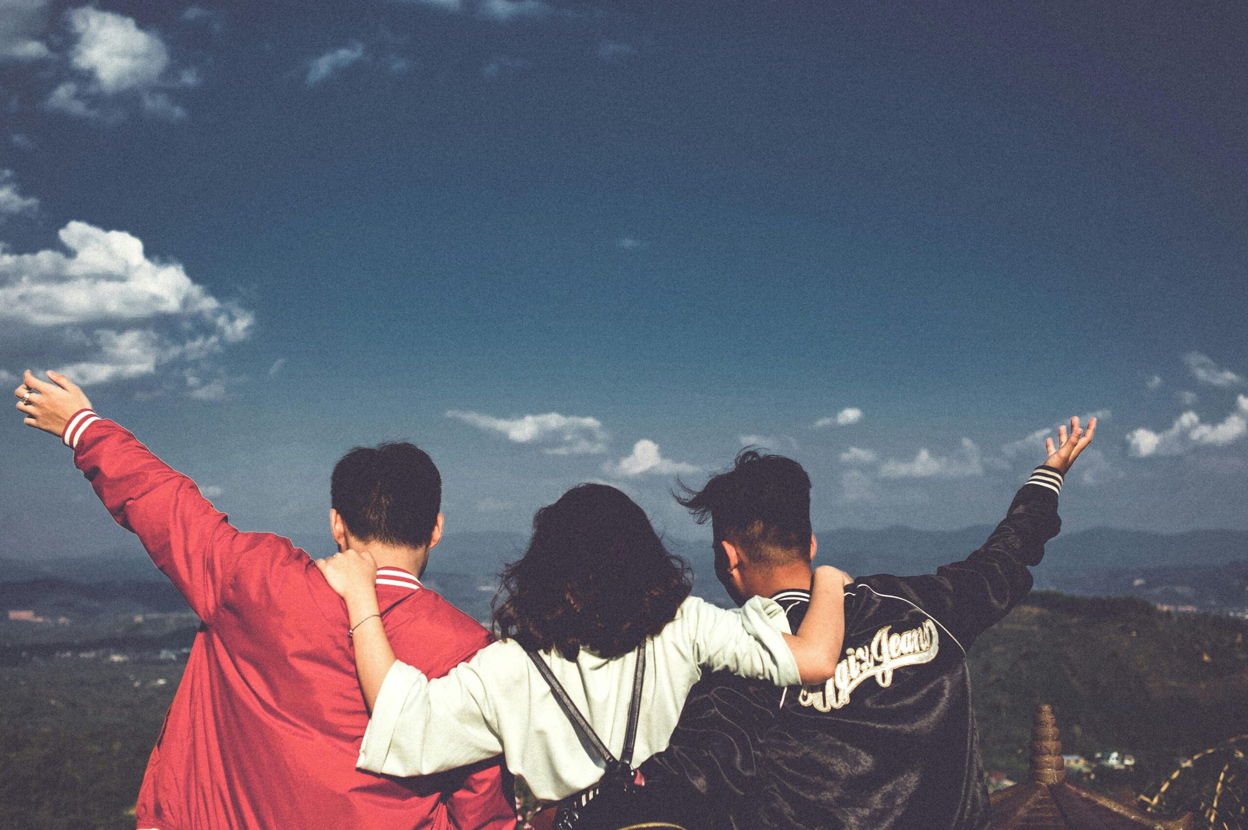 Three friends enjoying a scenic view together.