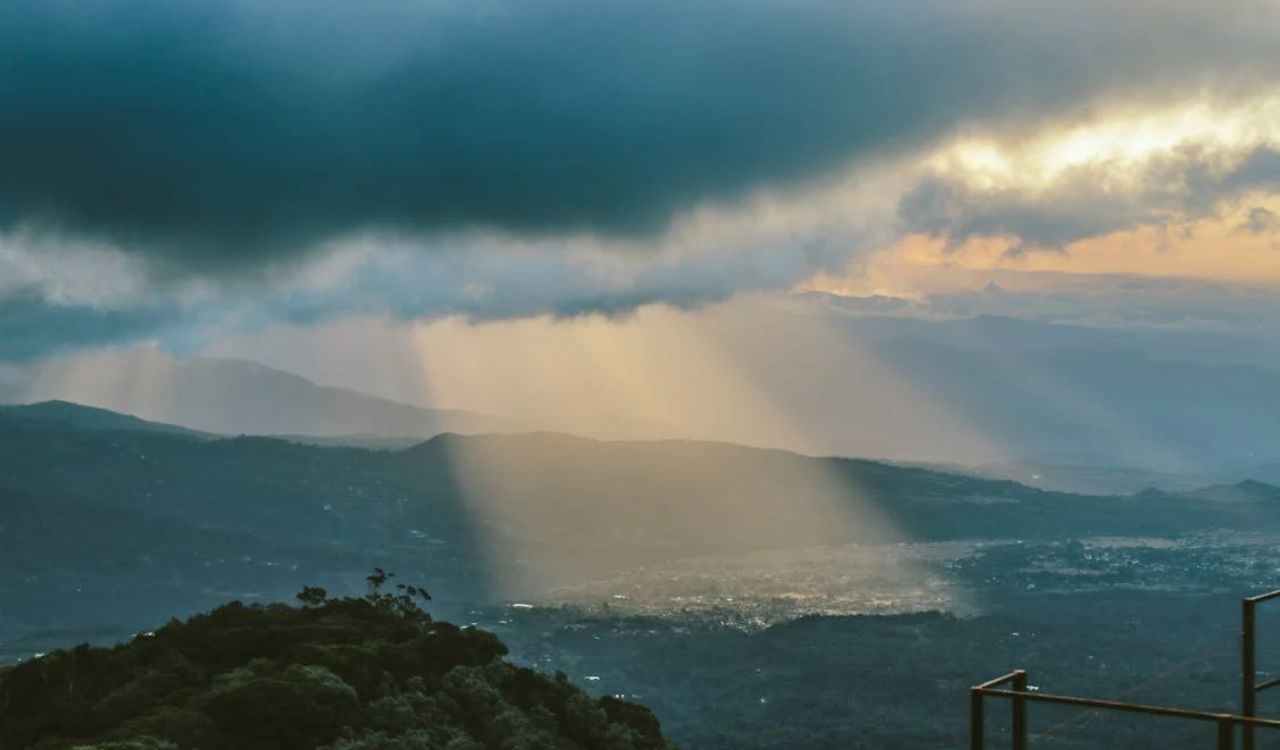 Sunbeams breaking through clouds over Costa Rica’s lush mountains and valleys