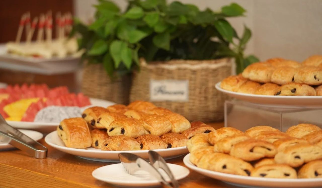 Plates of fresh pastries and colorful fruit on display