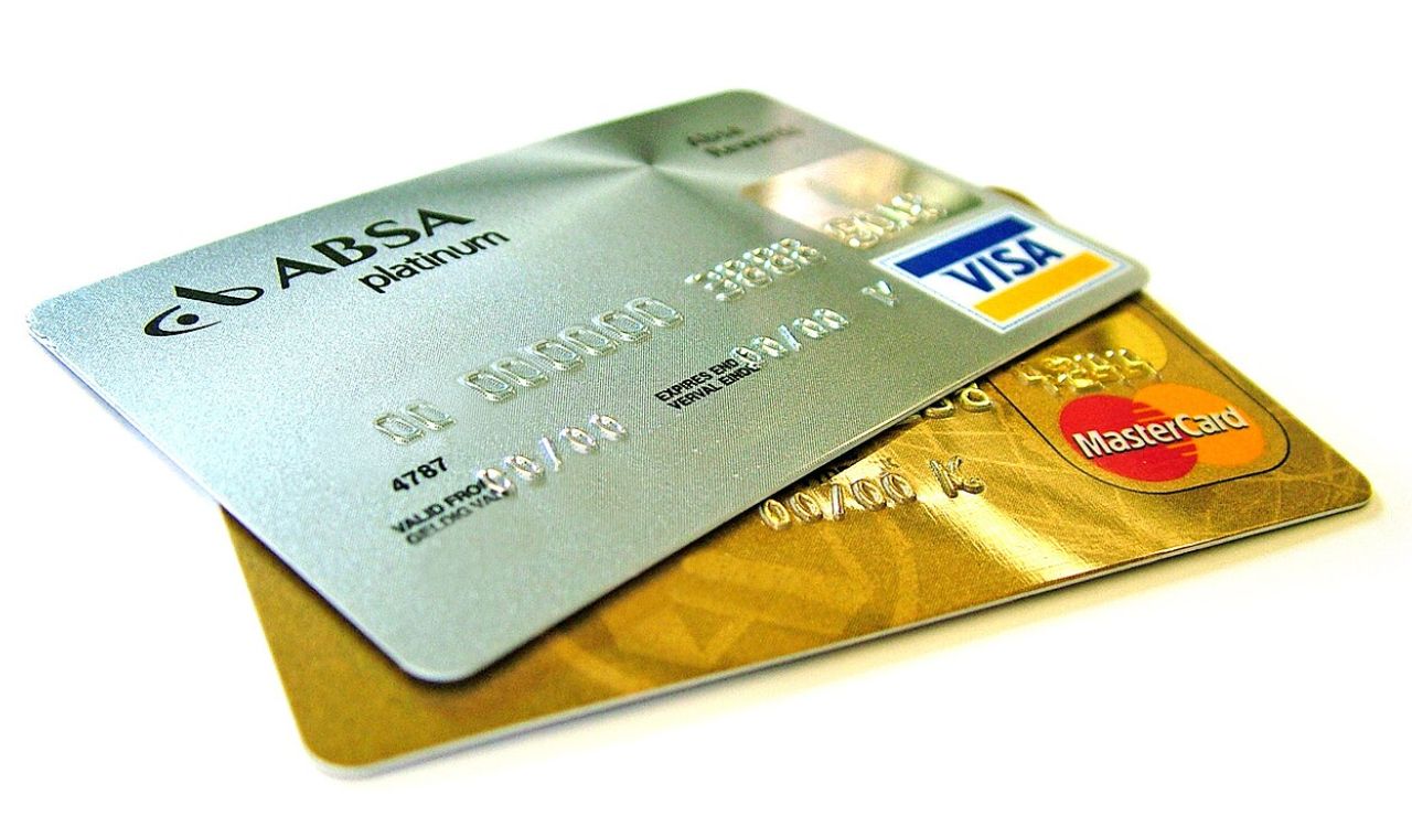 Visa and MasterCard credit cards stacked together, with an ABSA Platinum card on top