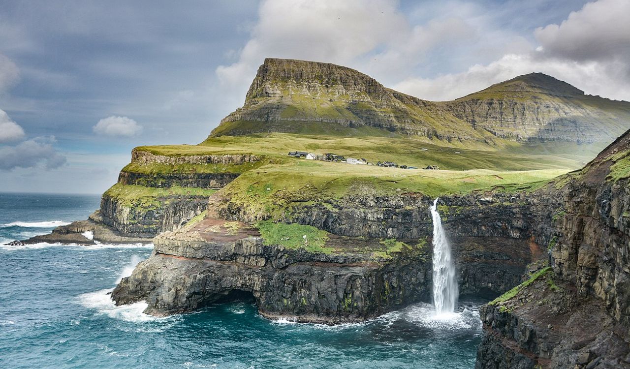 Mulafossur waterfall plunging into the Atlantic beside Gásadalur village, Faroe Islands