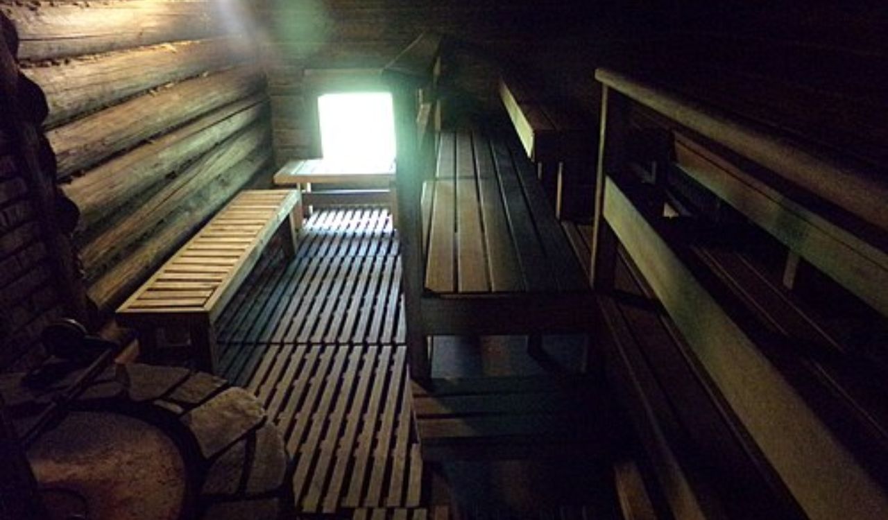 Traditional Finnish wooden sauna with benches and stove