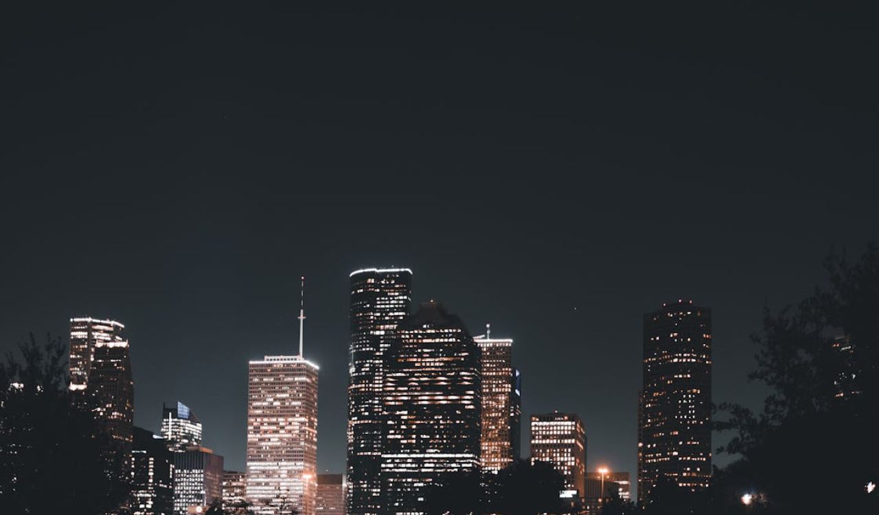 Houston skyline lit up at night, showcasing Texas’s vast urban landscape