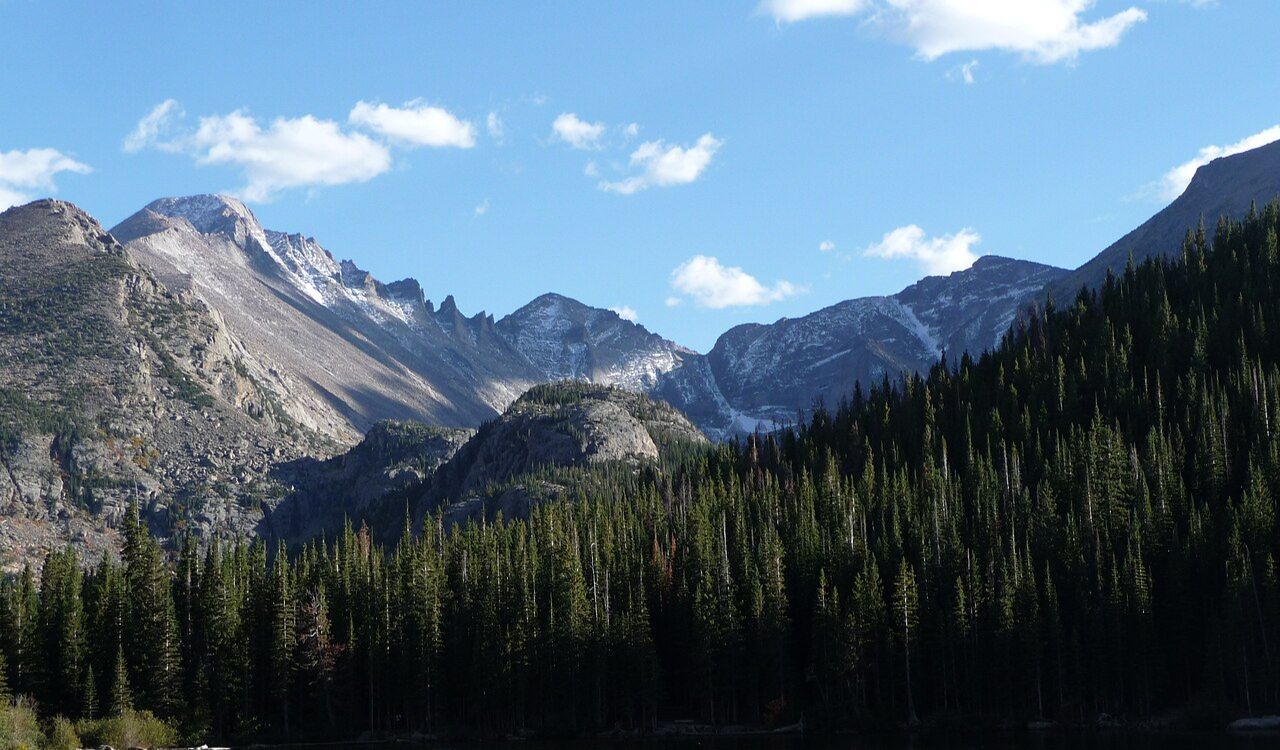 Snow-dusted peaks and dense pine forest in Glacier Gorge, Rocky Mountain National Park, Colorado