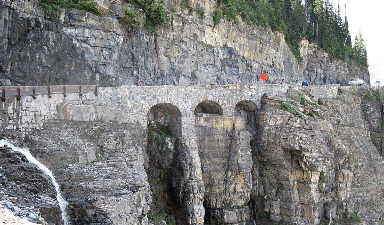 Going-to-the-Sun Road in Montana cuts through Glacier National Park, offering epic views of towering peaks, deep valleys, and cascading waterfalls